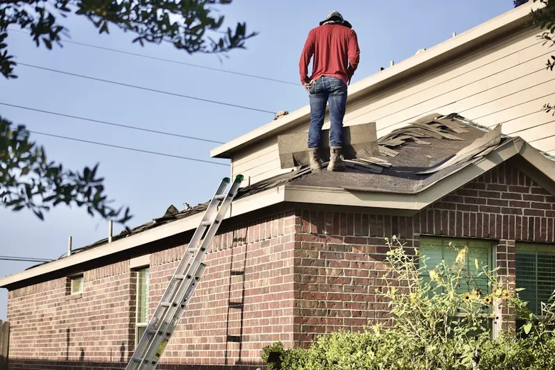 Professional roofer working on a residential roof in McClimansville